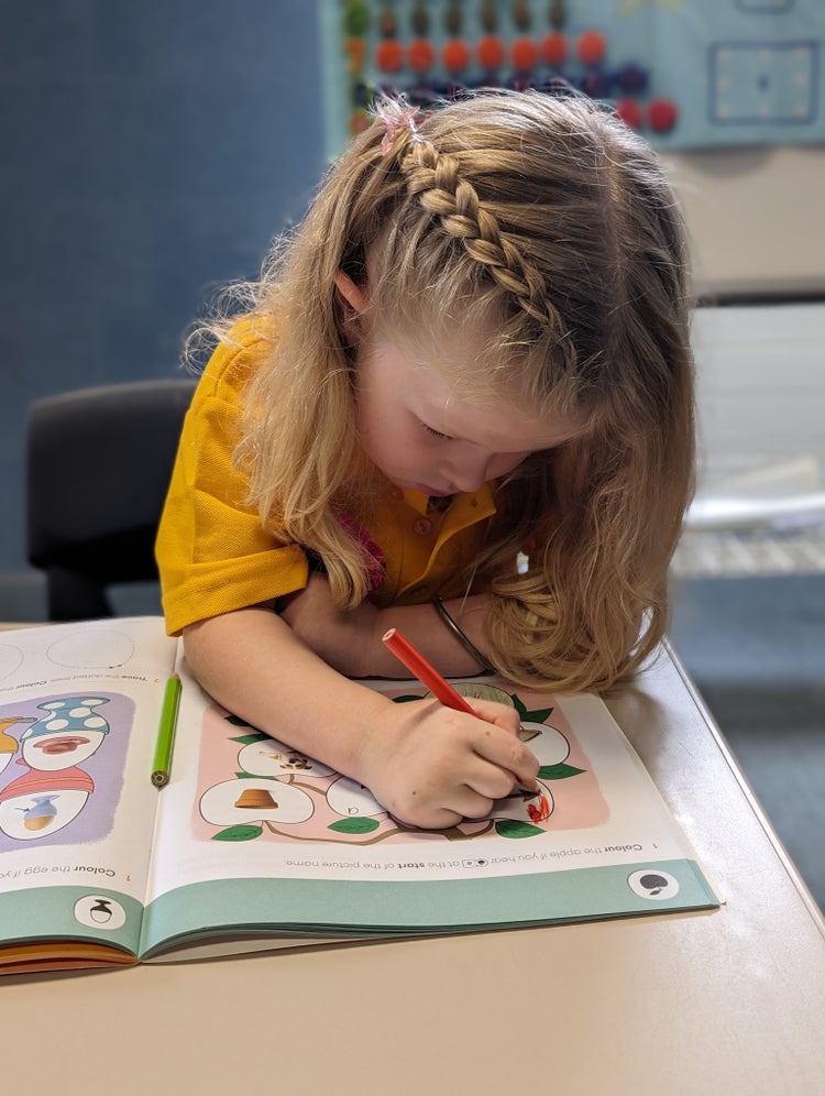 A female student colouring in